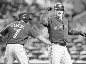 Toronto's Ben Revere celebrates with Josh Donaldson after scoring on Donaldson's first-inning, two-run home run off New York Yankees starting pitcher Luis Severino Friday.