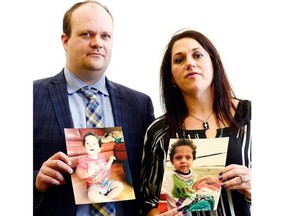 Peter Kot, left, and his wife Sylvie Fortier-Kot, hold up photos of their four-year-old son Kayden is being denied medical treatment in the US. This photo was taken at the Legislative Building in Regina on Wednesday.