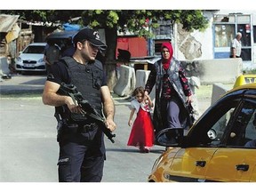 A Turkish police officer checks identities in Ankara on Monday. Turkey has called a meeting of its NATO allies to discuss threats to its security as well as its airstrikes on Syria.