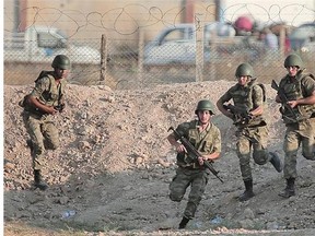 Turkish soldiers run to take positions next to the border fence in Akcakale. Turkey's press is abuzz with talk of plans for an intervention in Syria aimed at pushing ISIL back and outflanking any Kurdish attempt at creating a state.