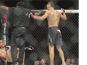 Ultimate Fighting Championship featherweight Max Holloway, right, beat Charles Oliveira, who verbally submitted during the Aug. 23 main event of UFC Fight Night in Saskatoon after suffering what company officials say was a micro tear of his esophagus.