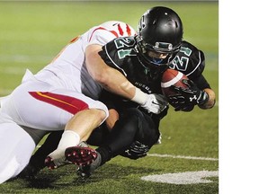 University of Saskatchewan Huskies Brett Boechler is brought down by a Calgary Dinos defender on Oct. 16. The 2-4 Huskies host UBC on Friday angling for a playoff spot.