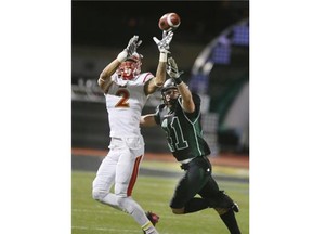 University of Saskatchewan Huskies Vince Greco is on top of Calgary Dinos receiver is pursued by Calgary Dinos Rashuan Simonise on Oct. 16, 2015 in Saskatoon. {