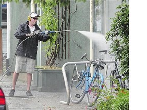 A man uses a power washer in spite of Metro Vancouver's Stage 3 water restrictions Wednesday.
