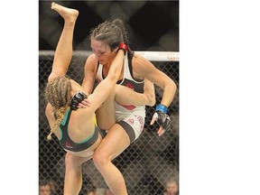Valerie Letourneau, top, breaks a hold from Maryne Moroz during a women's strawweight bout, part of the UFC fight night at SaskTel Centre on Sunday.
