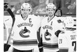 Vancouver's Henrik Sedin, left, celebrates his goal with his brother Daniel during Wednesday's NHL season opener in Calgary. The Canucks spoiled the Flames' home-opener with a 5-1 win.