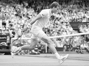 Vancouver's Vasek Pospisil runs into the net during a point against Britain's Andy Murray in their quarter-final match at Wimbledon on Wednesday. Murray won 6-4, 7-5, 6-4.