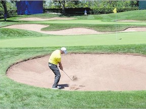 Vaughn Taylor hits out of a bunker onto the 17th green during the first round of play at the Canadian Open on Thursday in Oakville, Ont. He's tied for second at 7-under. The leader is relative unknown Emiliano Grillo, at 8-under.