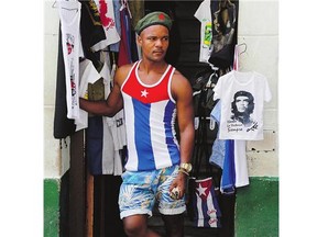 A vendor sells T-shirts featuring Che Guevara, in the shop's doorway, in Old Havana, Cuba.