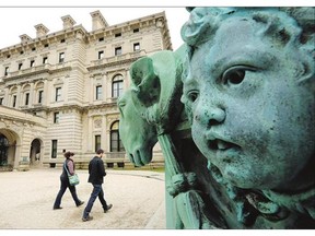 Visitors walk past a lamppost sculpture, right, near an entrance to The Breakers mansion, in Newport, R.I. The Vanderbilt family has fallen into a full-blown public spat with the organization that now owns their spectacular 70-room mansion.