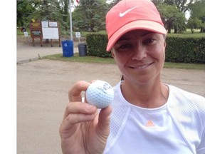 Kim Walker displays a golf ball that bears an image she scribbled of her ailing father. (Darren Zary/The StarPhoenix)
