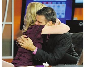 WDBJ-TV7 news morning anchor Kimberly McBroom hugs meteorologist Leo Hirsbrunner following their Thursday morning newscast, a day after a gunman shot dead two colleagues.