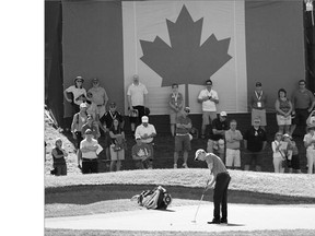 With the Canadian flag serving as the backdrop, David Hearn of Brantford, Ont., finishes up his second round 64 Friday at the Canadian Open in Oakville, Ont. Hearn sits three strokes back of the leader Chad Campbell at the midway point.