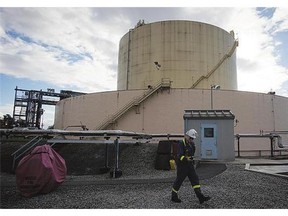 A worker walks past a storage tank at the existing FortisBC Tilbury LNG facility. A new report examines the prospects for new liquid natural gas export facilities in B.C.