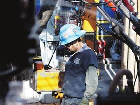 A worker on a Williams natural gas rig. Energy Transfer Equity LP is paying $37.7B in a takeover bid for Williams.