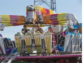 Workers set up midway rides on August 3, 2015 in preparation for the Saskatoon Ex which runs this week.