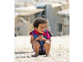 A young Syrian refugee looks on at the UN-run Zaatari camp, northeast of the Jordanian capital Amman, on Sept. 19. Canada's Conservative government has rejected calls to increase aid spending to the international target of 0.7 per cent of GDP.