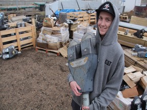Eighteen-year-old Brady Hovdestad can be seen carrying one of the City of Saskatoon's old parking meters on Wednesday afternoon. For $31 dollars, the teenager said he feels he paid a good price for what could soon be a Saskatoon antique.