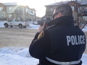 A Saskatoon Police officer checks vehicle speeds along McClocklin Road in Hampton Village.