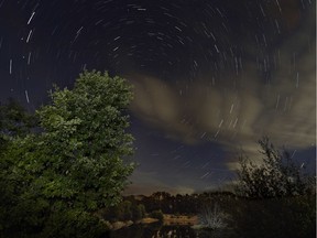 A multiple exposure picture taken in the early hours of August 12, 2014 shows a Perseids meteor shower in the night sky from the mountains of the Sierra Norte de Madrid near the municipality of Valle del Lozoya.  The perseid meteor shower occurs every year in August when the Earth passes through the debris and dust of the Swift-Tuttle comet.