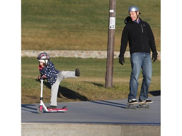 Four-year-old Evan Chapman does a little trick riding at the Lion Skate Park with her dad Rene on November 12, 2015. Her father says he and some other dads try to bring a group of their kids out there to enjoy the facility.