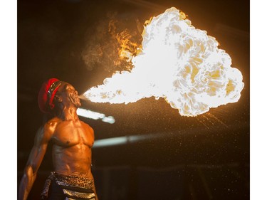 Prince Niah plays with fire in the Caribbean pavilion of Folkfest at Prairieland Park, August 13, 2015.