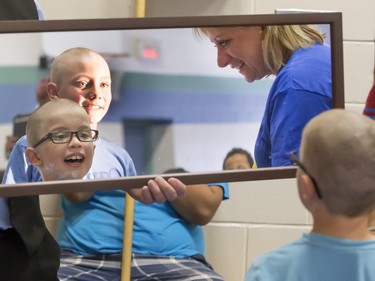 Teachers and students were given haircuts and head shaves during the Sutherland School Shave for the Brave,  June 11, 2015. Stylists from Chel Salon Spa were in charge of cutting for the event. Here Braden Hammet (front with glasses) reacts to seeing himself in the mirror after a shave by Kim Regier.