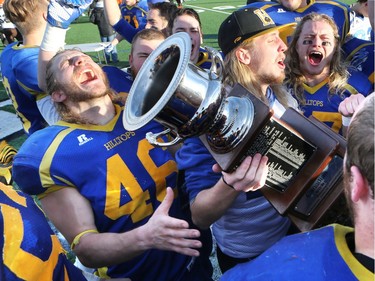 The Saskatoon Hilltops win their 18th national title 38-24 against the Okanagan Sun in Saskatoon, November 7, 2015. Austin Thorarinson, who was injured and unable to play in the game, was the first to hold the cup under the direction of coach Tom Sergeant.