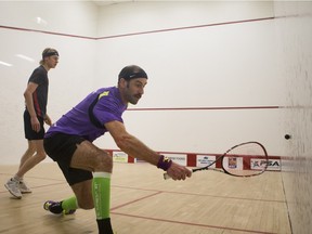 Tom Ford, left, takes on Steven Finitsis during the championship match of the Saskatoon Movember Boast International Squash Tournament at the YMCA on Sunday.