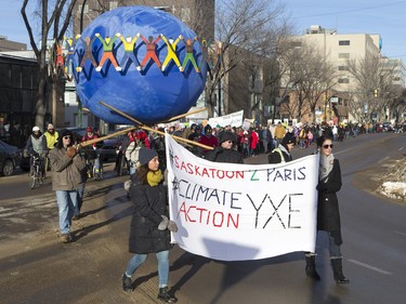 People walk down the Broadway Bridge during a march and rally for the climate called Saskatoon2Paris, November 29, 2015.