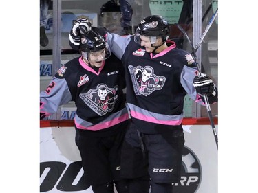 Calgary Hitmen's Jake Bean celebrates his goal with teammate Beck Malenstyn against the Saskatoon Blades in WHL action at the Scotiabank Saddledome in Calgary, November 22, 2015.