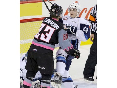 Calgary Hitmen's Taylor Sanheim gets in a shoving match with Saskatoon Blades' Schael Higson in WHL action at the Scotiabank Saddledome in Calgary, November 22, 2015.