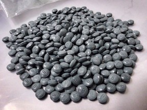 Fentanyl pills are shown in an undated police handout photo. Another fentanyl arrest has two police forces and Alberta's health agency working together to raise awareness about the dangerous drug. A Calgary man has been charged after a joint investigation by the Canadian Border Services Agency, the RCMP and Calgary police.