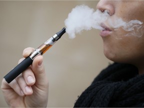 A person smokes an electronic cigarette in Paris.