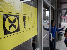 ***FREELANCE PHOTO - POSTMEDIA NETWORK USE ONLY*** TORONTO, ON: MAY 2, 2011 -- People exit the Neill-Wycik Student Co-op and Hotel where an Elections Canada sign indicates it as a polling site. (Matthew Sherwood for National Post) ORG XMIT: POS2014040819160741