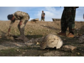 Kurdish Peshmerga show what they say is a mass grave of Yazidis killed by ISIL in Sinjar, Iraq.