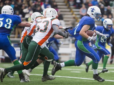 Moose Jaw Peacock Tornadoes #53 Kayne Pasquet attempts to tackle Saskatoon Bishop Mahoney Saints' Ryan Hill in 3A Football Provincial finals at SMS field in Saskatoon, November 14, 2015.