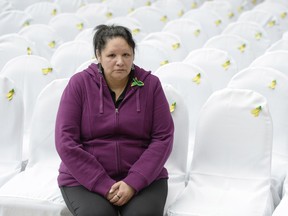 Carol Wolfe sits in Regina on May 5, 2014, on one of the 118 seats representing Saskatchewan's long-term missing people, including her daughter Karina Beth Ann Wolfe, who was last seen in Saskatoon on July 2, 2010.