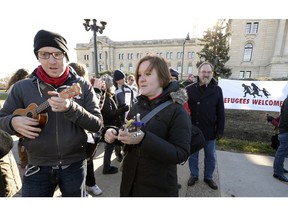 Protesters at the legislature called on Premier Wall to reverse his go-slow stance on refugees.