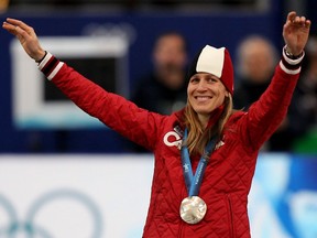 Kristina Groves of Canada waves to the crowd after being awarded the silver medal in the women's 1,500-meter speedskating competition during the 2010 Winter Olympics.