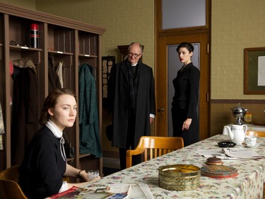 L-R: Saoirse Ronan as Eilis, Jim Broadbent as Father Flood and  Jessica Paré as Miss Fortini in "Brooklyn."