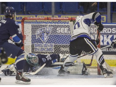 Saskatoon Blades goaltender Nik Amundrud makes a toe save against Victoria Royals forward Ryan Peckford during the first period of WHL action, November 1, 2015.