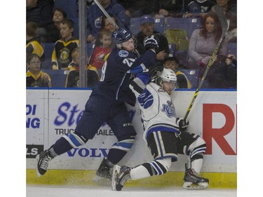 Saskatoon Blades forward Josh Uhrich hits Victoria Royals forward Dante Hannoun into the boards during the first period of WHL action, November 1, 2015.