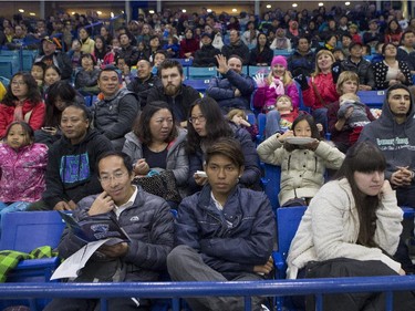 A group of Canadian newcomers watches as the Saskatoon Blades take on  the Victoria Royals during the second period of WHL action, November 1, 2015.