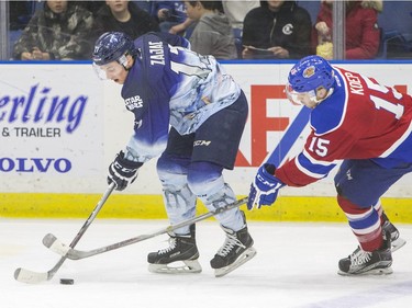 Saskatoon Blades forward Nick Zajac moves the puck away from Edmonton Oil Kings forward Andrew Koep in second period WHL action, November 28, 2015.