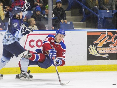Saskatoon Blades forward Cameron Hausinger knocks over Edmonton Oil Kings forward Dario Meyer in first period WHL action, November 28, 2015.