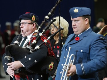 The largest indoor Remembrance Day service in Canada was held at SaskTel Centre in Saskatoon, November 11, 2015. Piper Brad Fenty with the Saskatoon Legion and bugler Lt. Aaron Vopni were on hand for the event. Behind them is Governor General Vaughn Solomon Schofeld.