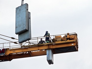 Construction of the Children's Hospital of Saskatchewan is underway, with two cranes on site as of mid-November. Here, counterweights are added to a construction crane.