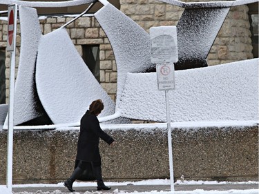 A snow-plastered sculpture in front of the Health Sciences Building on the University of Saskatchewan campus highlights the starkness of winter after the first snowfall in Saskatoon on November 18, 2015.