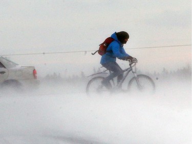 A cyclist in the first snowfall in Saskatoon, November 18, 2015.